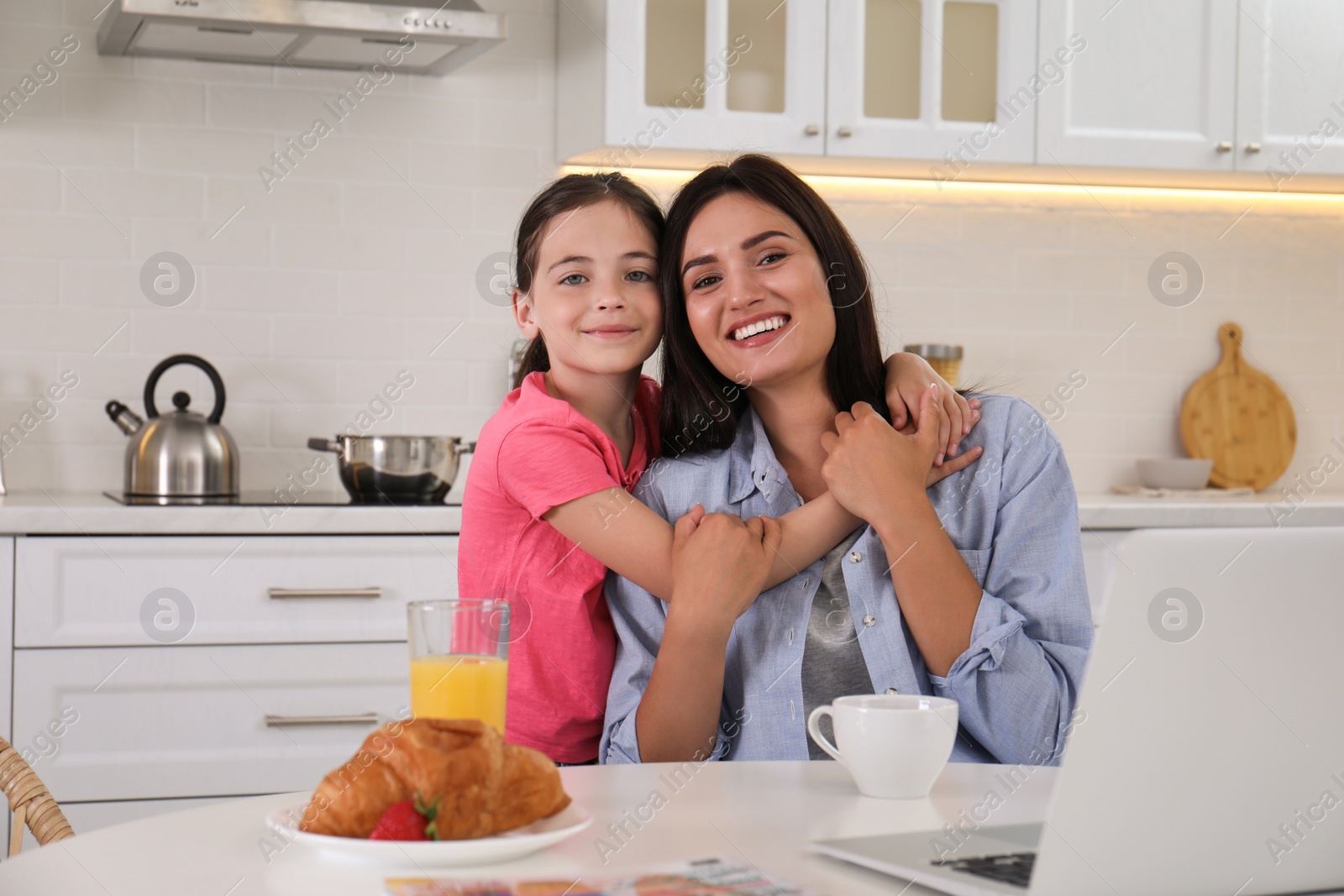 Photo of Portrait of happy mother and daughter together in kitchen. Single parenting