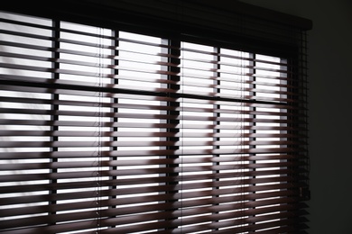 Photo of Modern window with stylish wooden blinds indoors