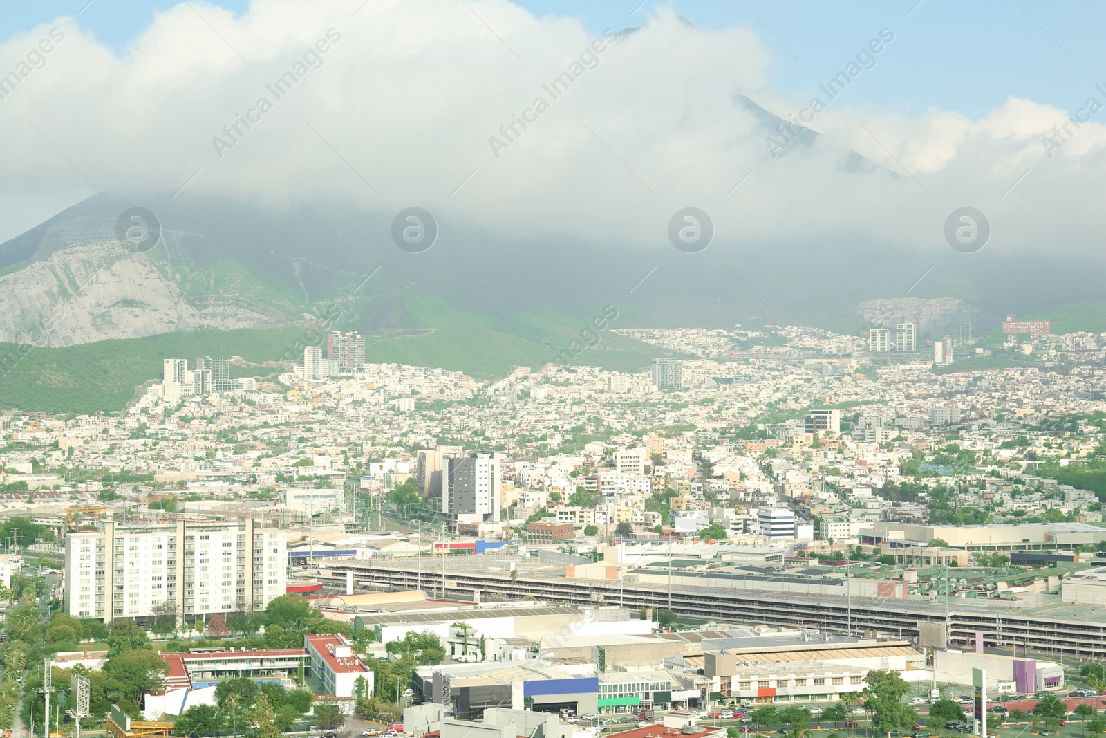 Photo of Picturesque view of cityscape with many buildings near mountain