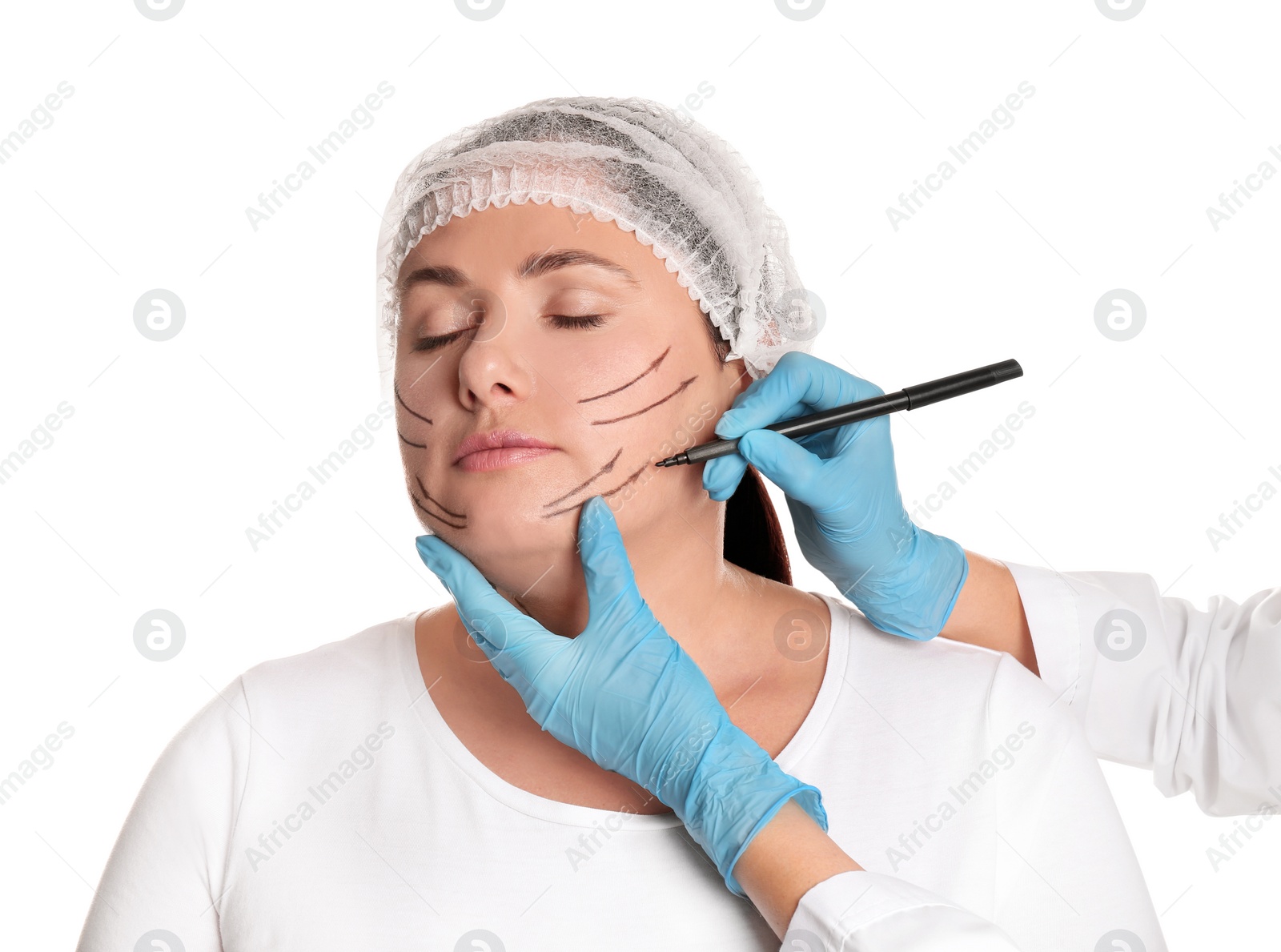 Photo of Doctor drawing marks on woman's face for cosmetic surgery operation against white background. Double chin problem