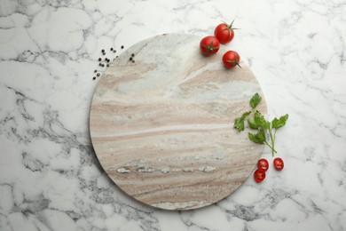 Photo of Cutting board, parsley, pepper and tomatoes on white marble table, flat lay. Space for text