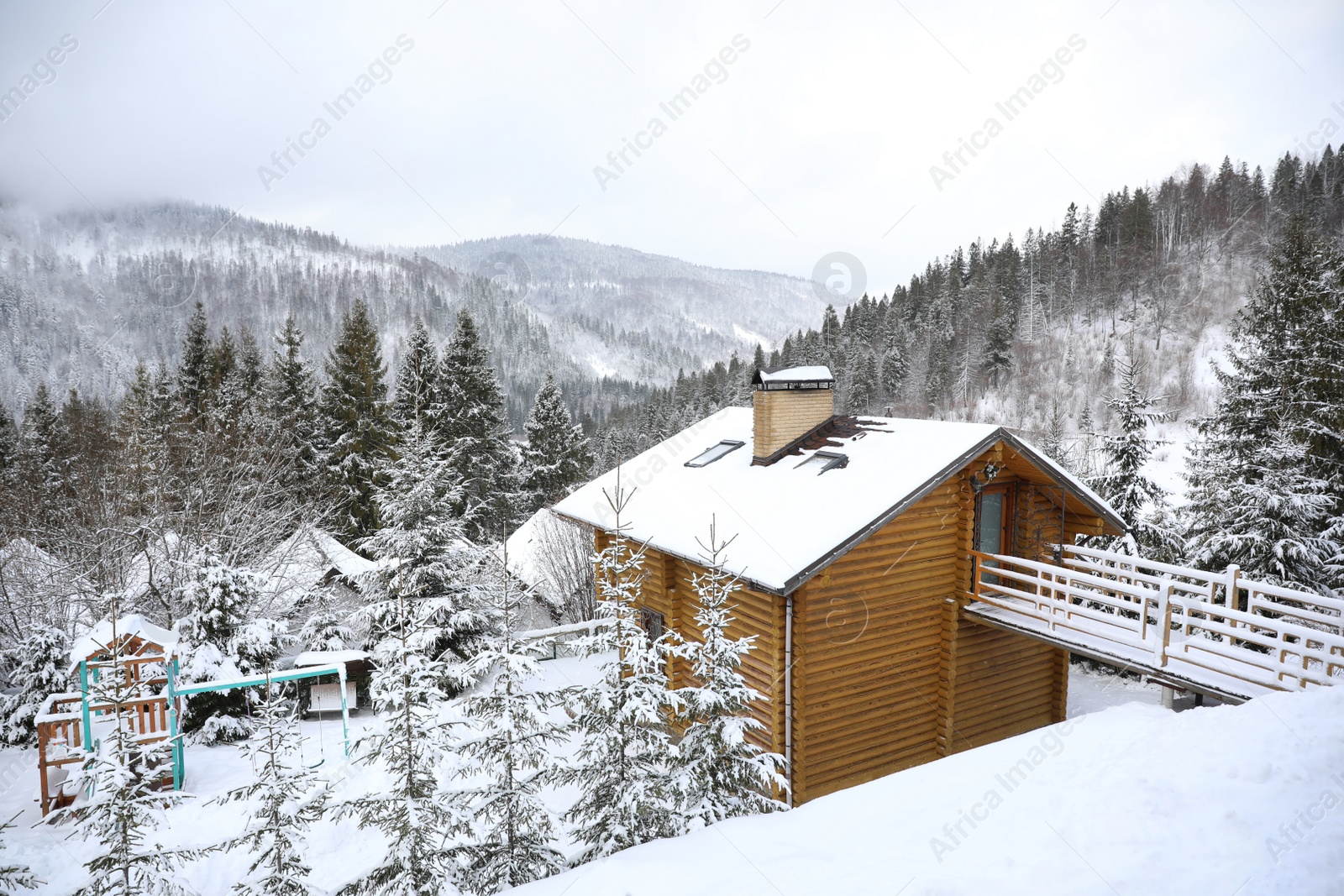 Photo of Beautiful landscape with cottage on snowy winter day