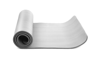 Photo of Rolled grey yoga mat on white background