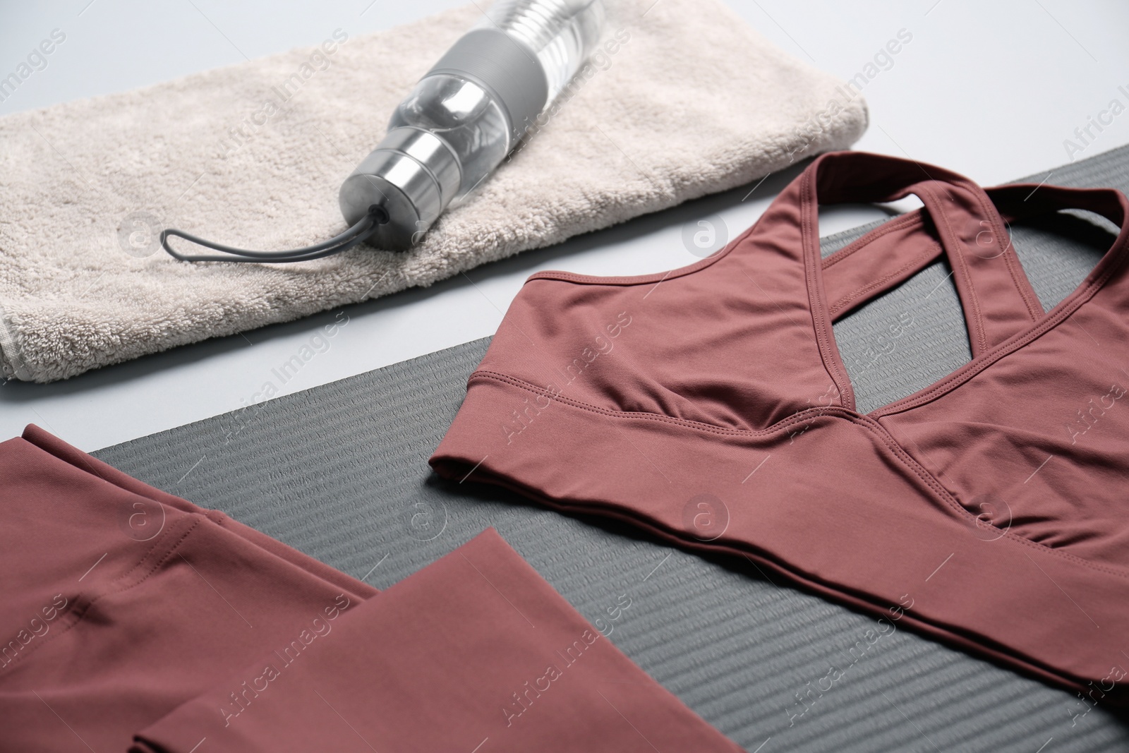 Photo of Composition with yoga equipment on grey background, closeup