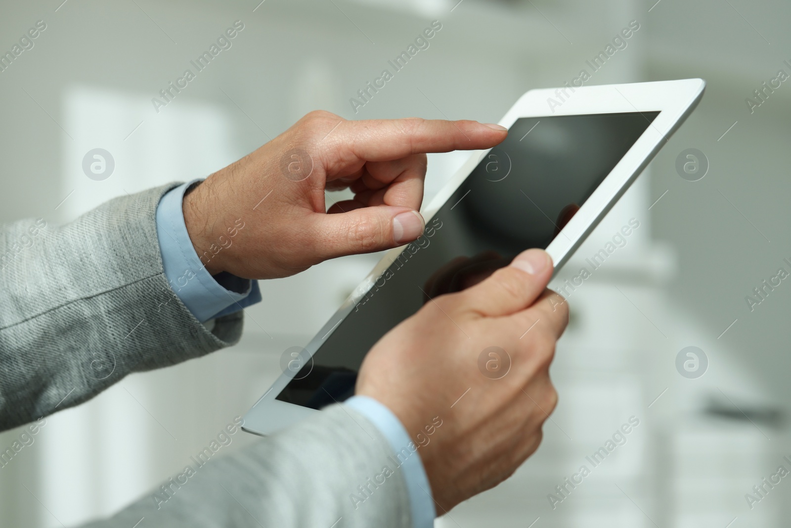 Photo of Closeup view of man using new tablet indoors