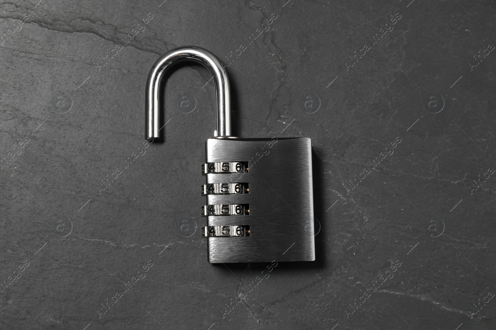 Photo of One steel combination padlock on black table, top view