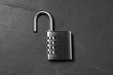 One steel combination padlock on black table, top view