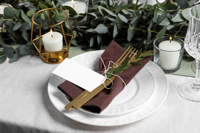 Luxury table setting with beautiful decor and blank card. Festive dinner