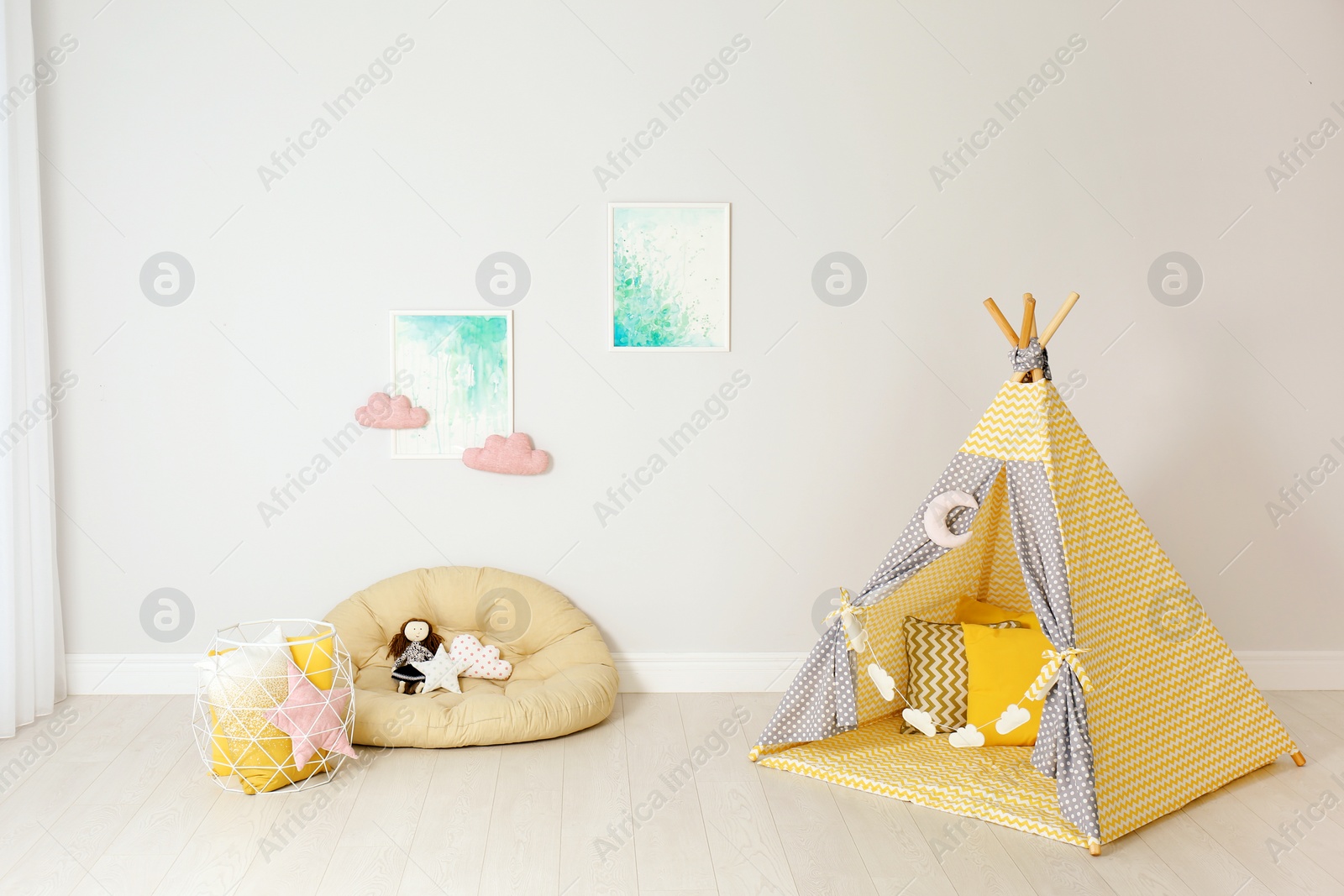 Photo of Modern nursery room interior with play tent for kids