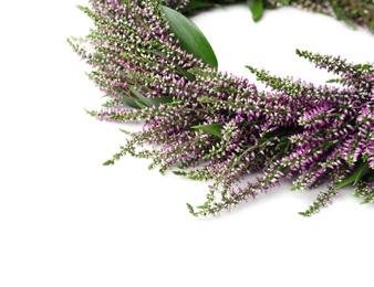 Beautiful autumnal wreath with heather flowers on white background, closeup