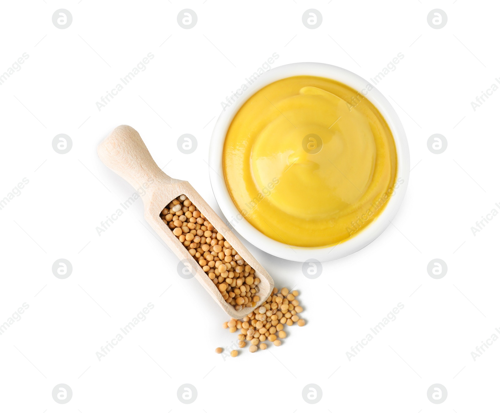 Photo of Bowl of delicious mustard and scoop with seeds on white background, top view