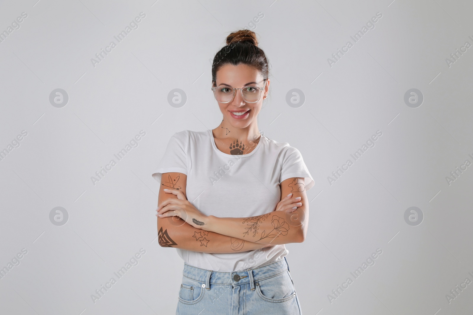 Image of Attractive woman with beautiful tattoo sketches on light background