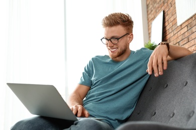 Young man using laptop in living room