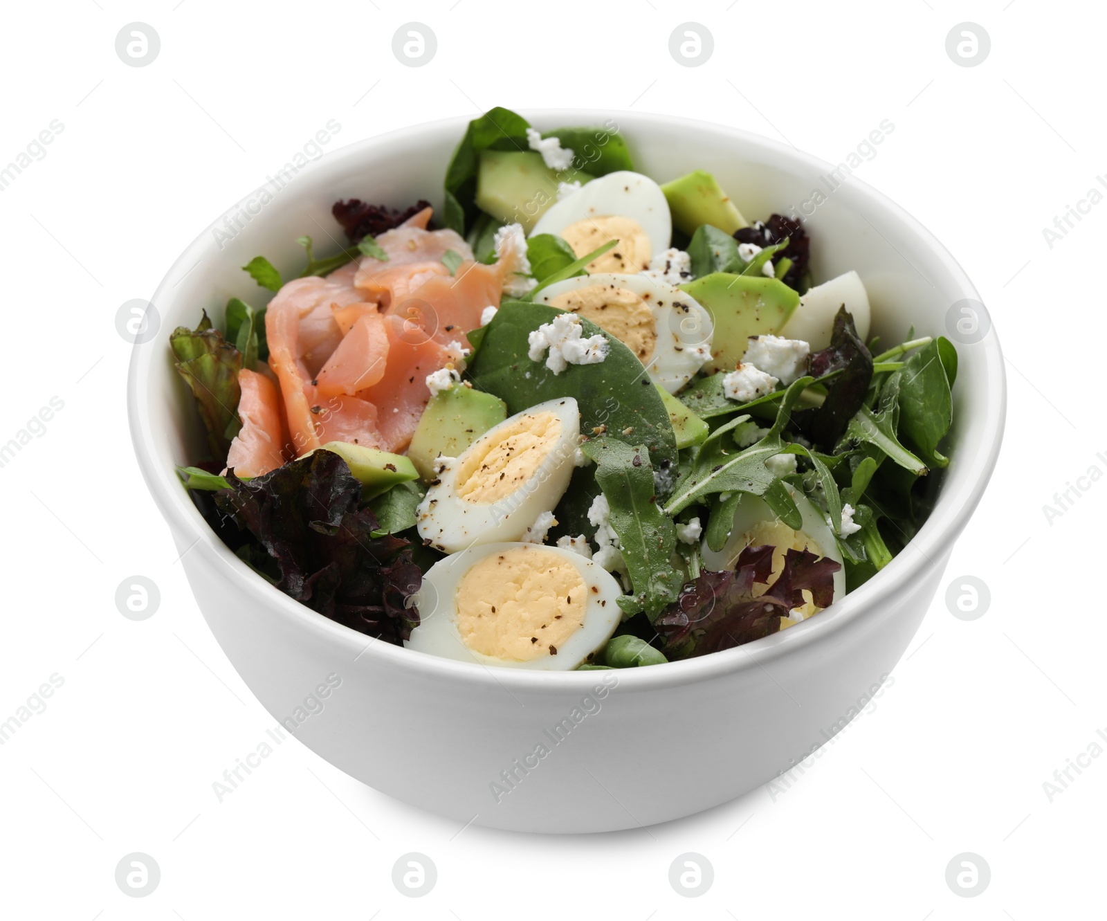 Photo of Delicious salad with boiled eggs, salmon and cheese in bowl isolated on white