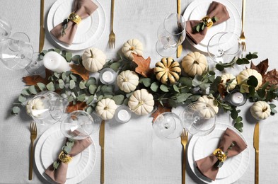 Photo of Beautiful autumn table setting. Plates, cutlery, glasses, pumpkins and floral decor, flat lay