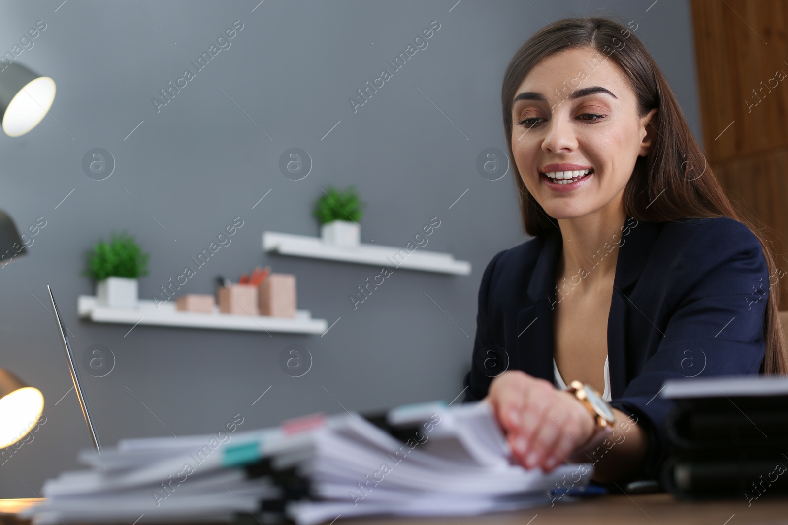 Photo of Beautiful businesswoman working with documents at table in office. Space for text