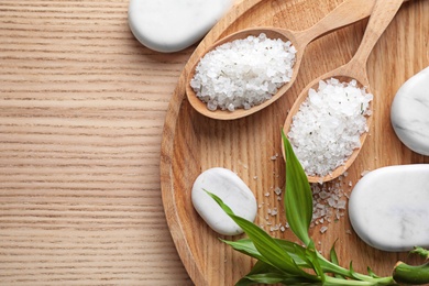 Photo of Flat lay composition with white sea salt on wooden background, space for text. Spa treatment