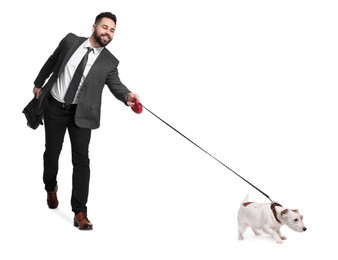 Smiling businessman walking with dog on white background
