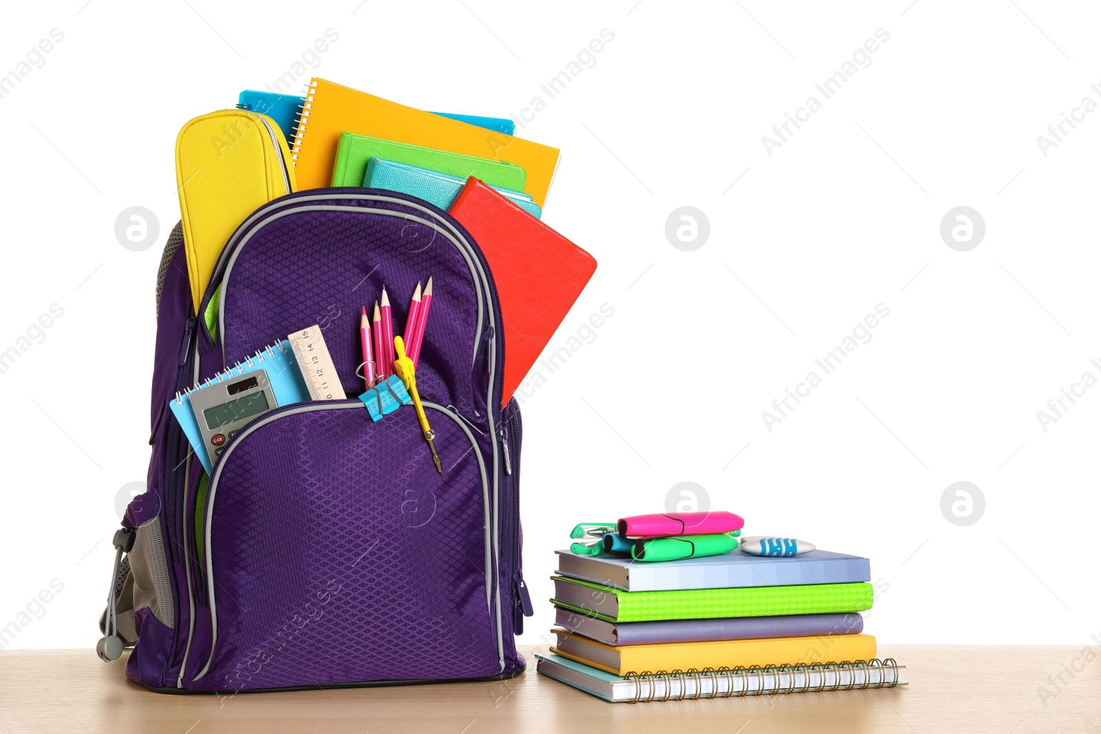 Photo of Color backpack with stationery on white background. Ready for school