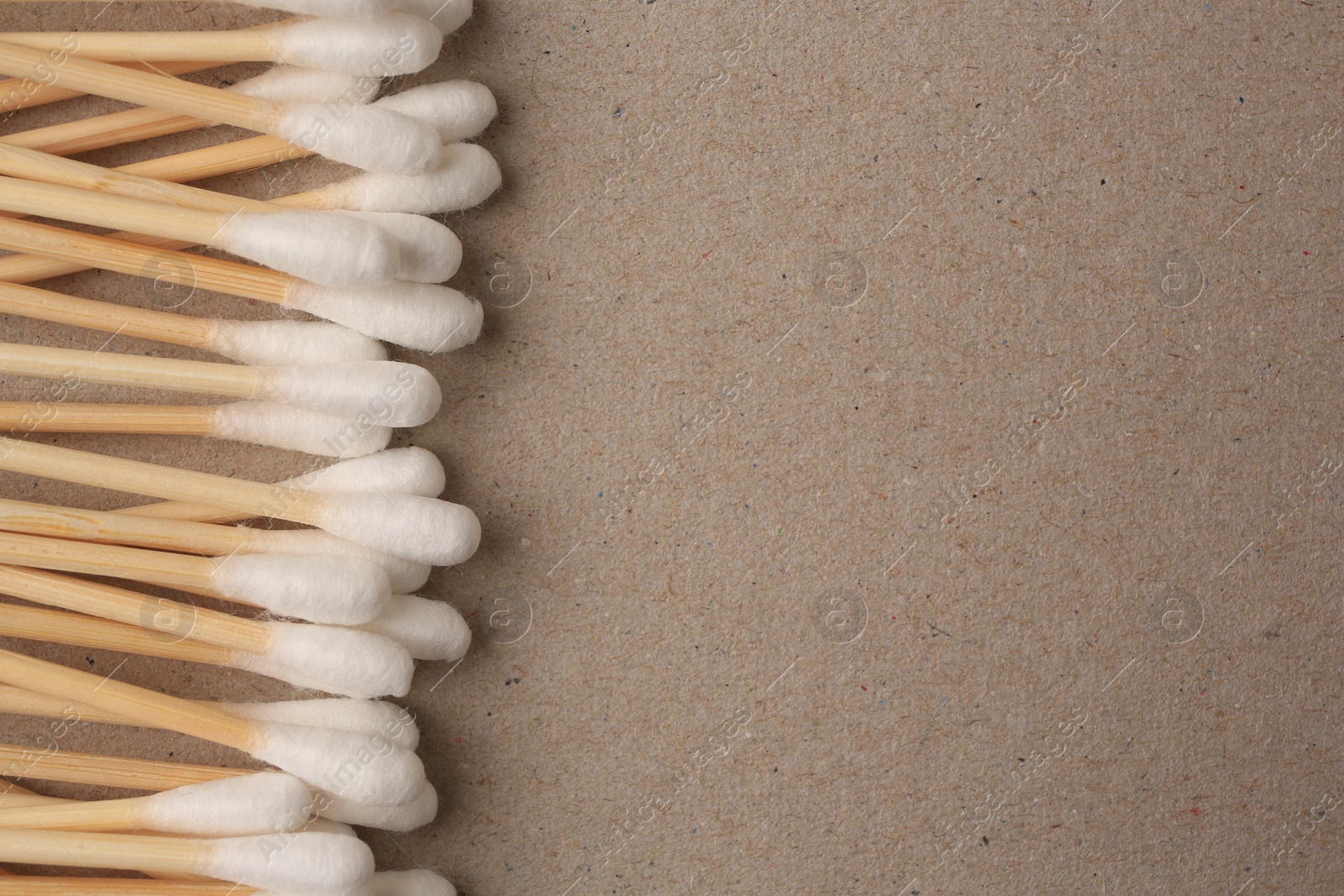 Photo of Many clean cotton buds on cardboard, flat lay. Space for text