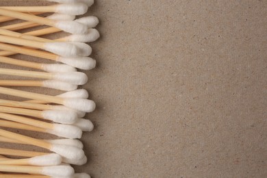 Photo of Many clean cotton buds on cardboard, flat lay. Space for text