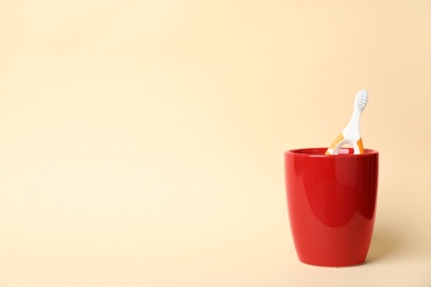 Photo of Baby toothbrush in holder and space for text on color background