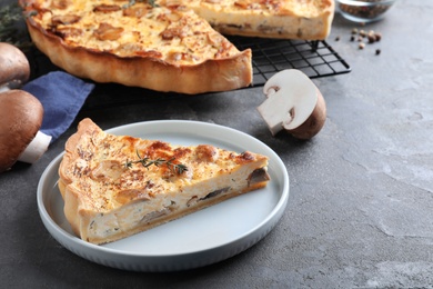 Delicious pie with mushrooms and cheese served on grey table