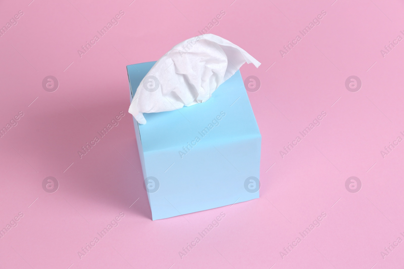 Photo of Box with paper tissues on pink background