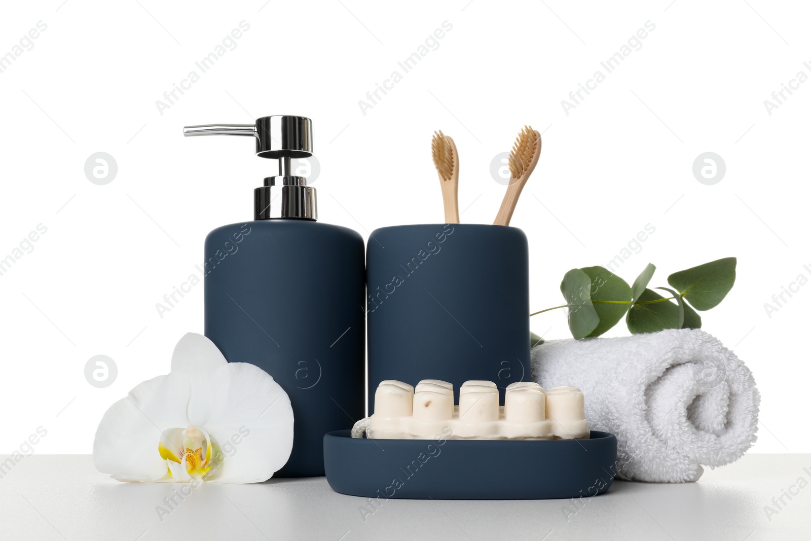 Photo of Bath accessories. Different personal care products, flower and eucalyptus branch on table against white background