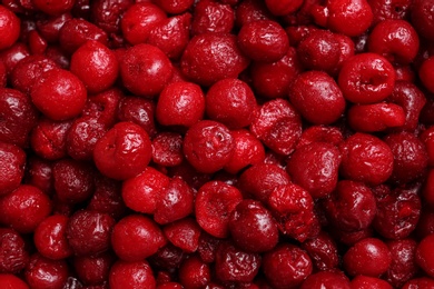 Photo of Pile of frozen cherries as background, closeup