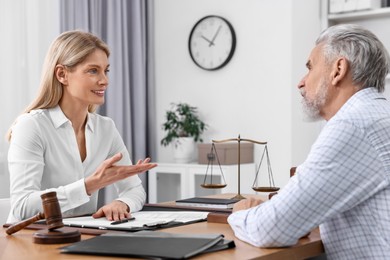 Photo of Senior man having meeting with lawyer in office