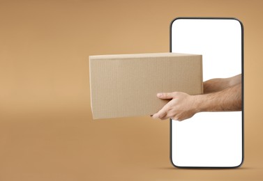 Courier passing parcel through smartphone on dark beige background. Delivery service