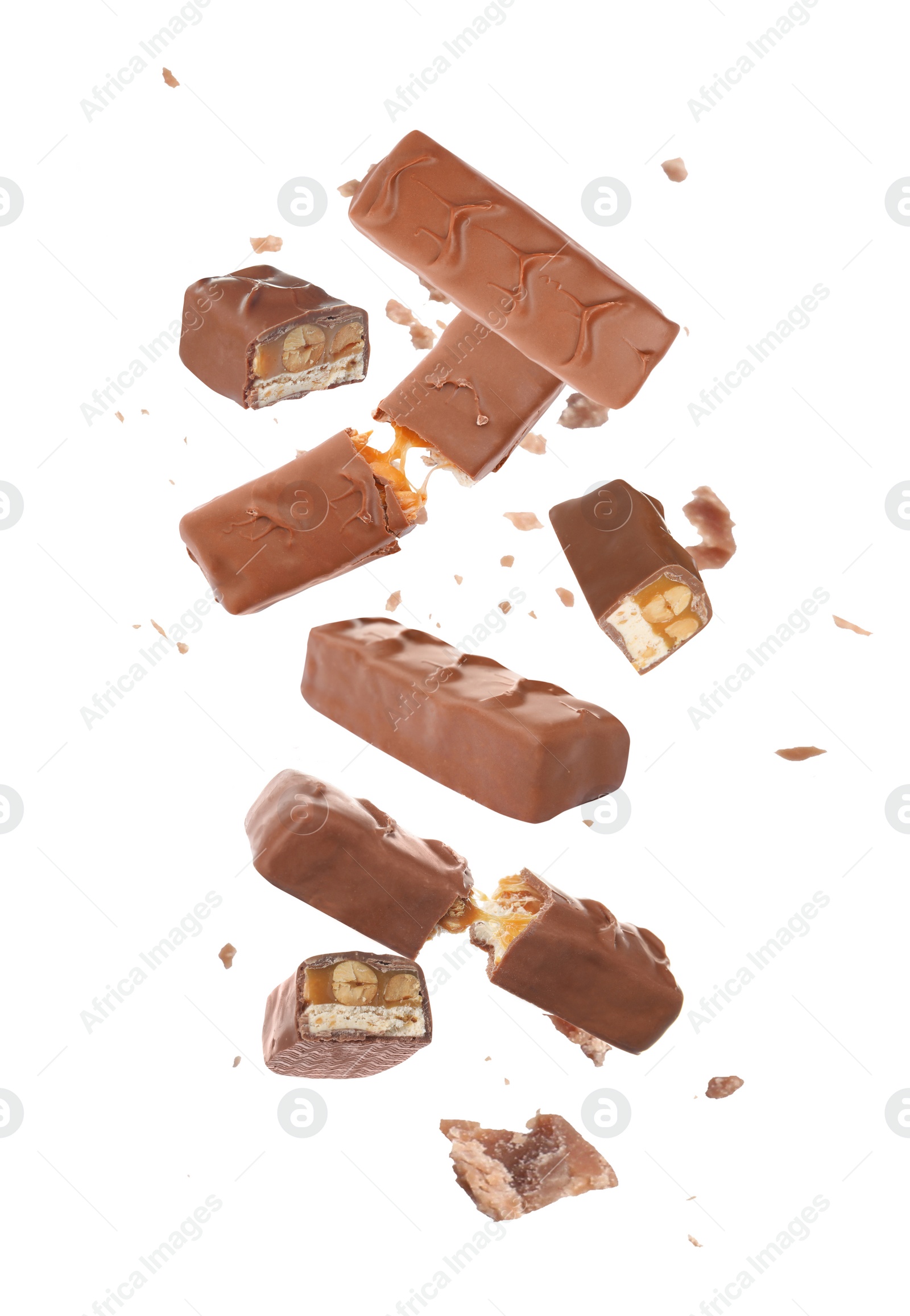 Image of Whole and broken chocolate bars with caramel, nuts and nougat falling on white background