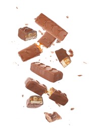 Image of Whole and broken chocolate bars with caramel, nuts and nougat falling on white background