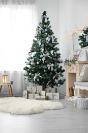 Stylish living room interior with decorated Christmas tree