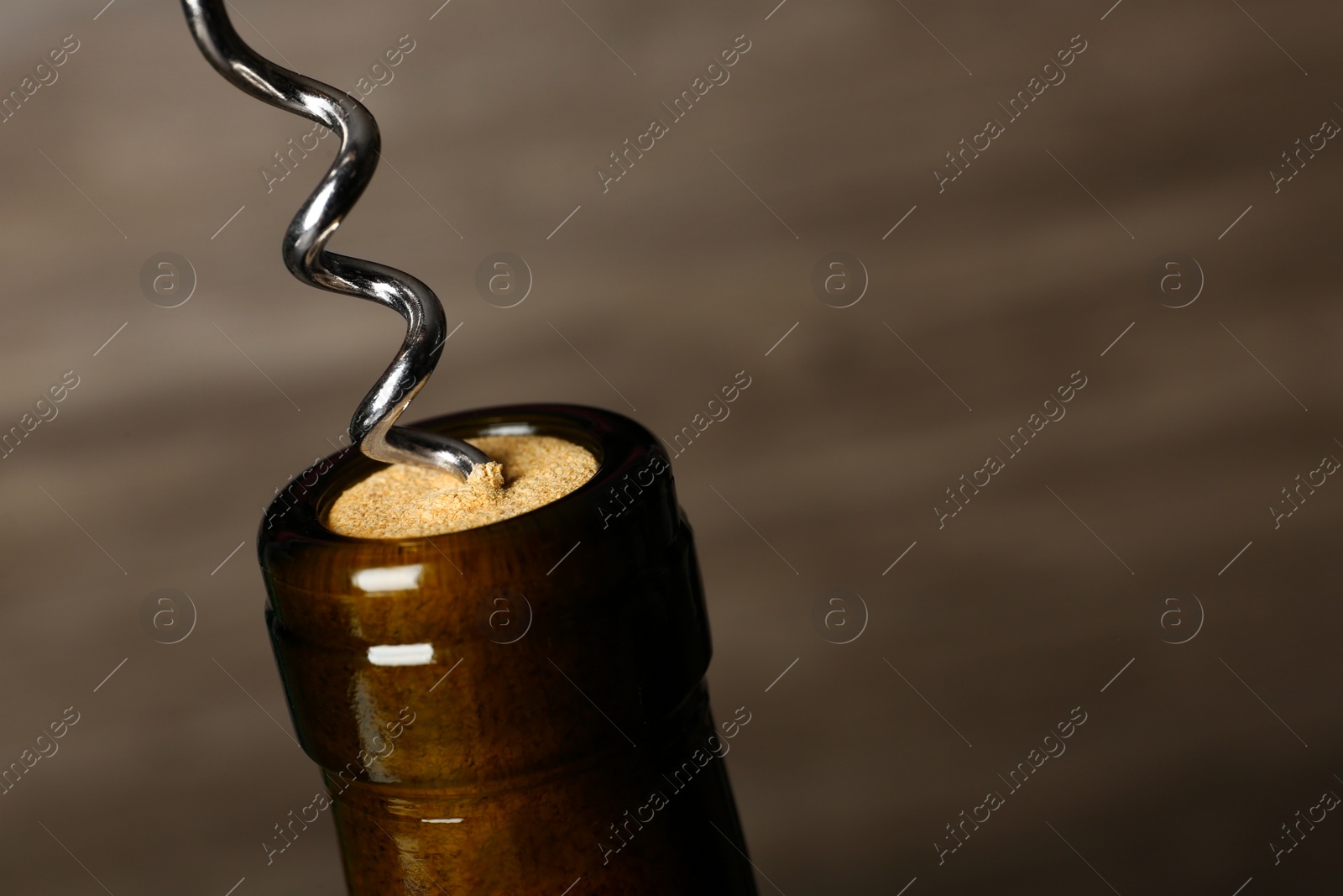 Photo of Bottle of wine and corkscrew on dark background, space for text