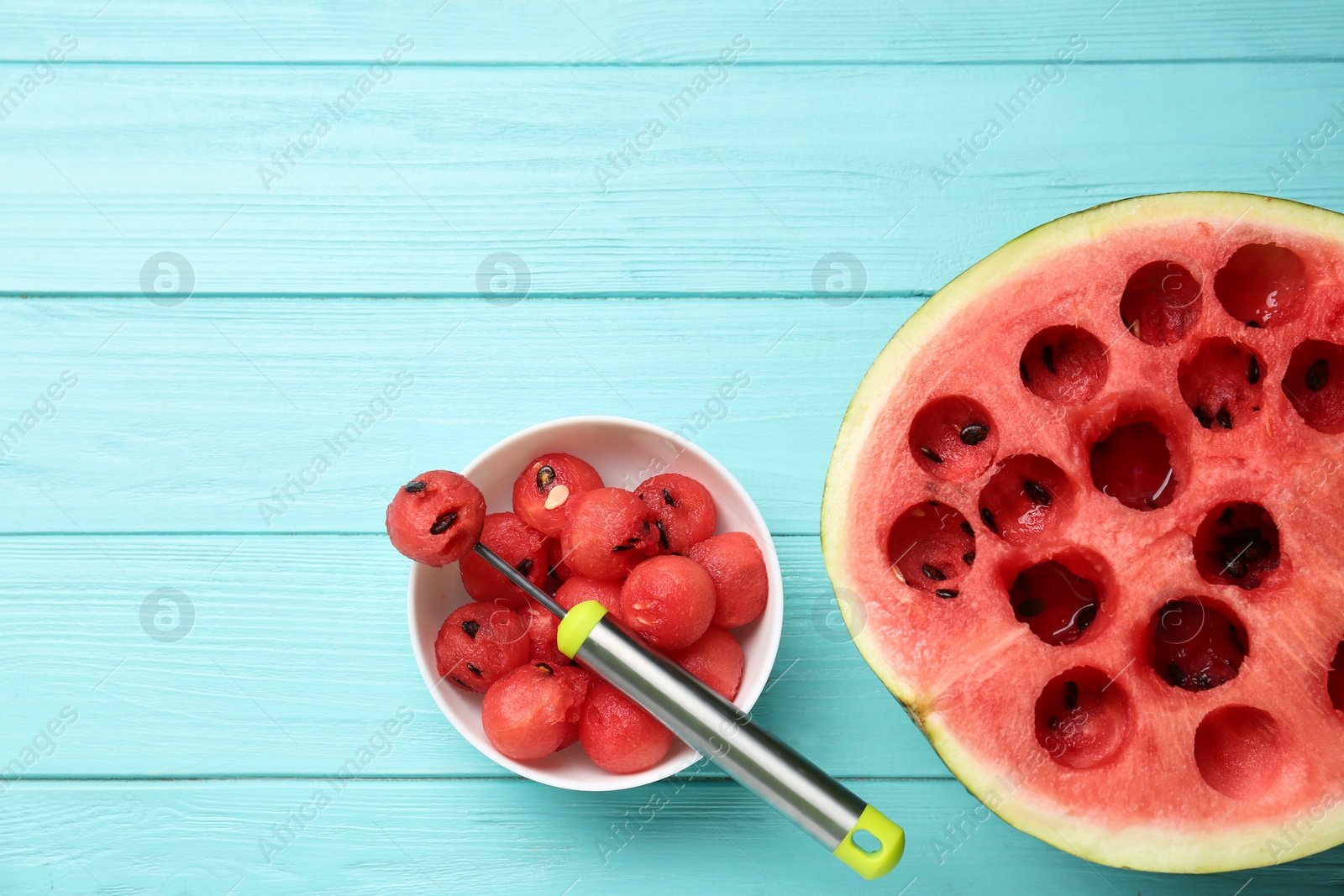 Photo of Flat lay composition with watermelon balls on light blue wooden background, space for text