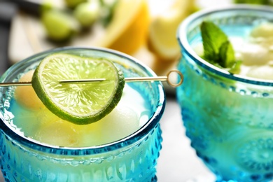 Photo of Melon ball cocktail served on table, closeup