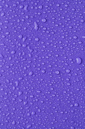 Water drops on lilac background, top view