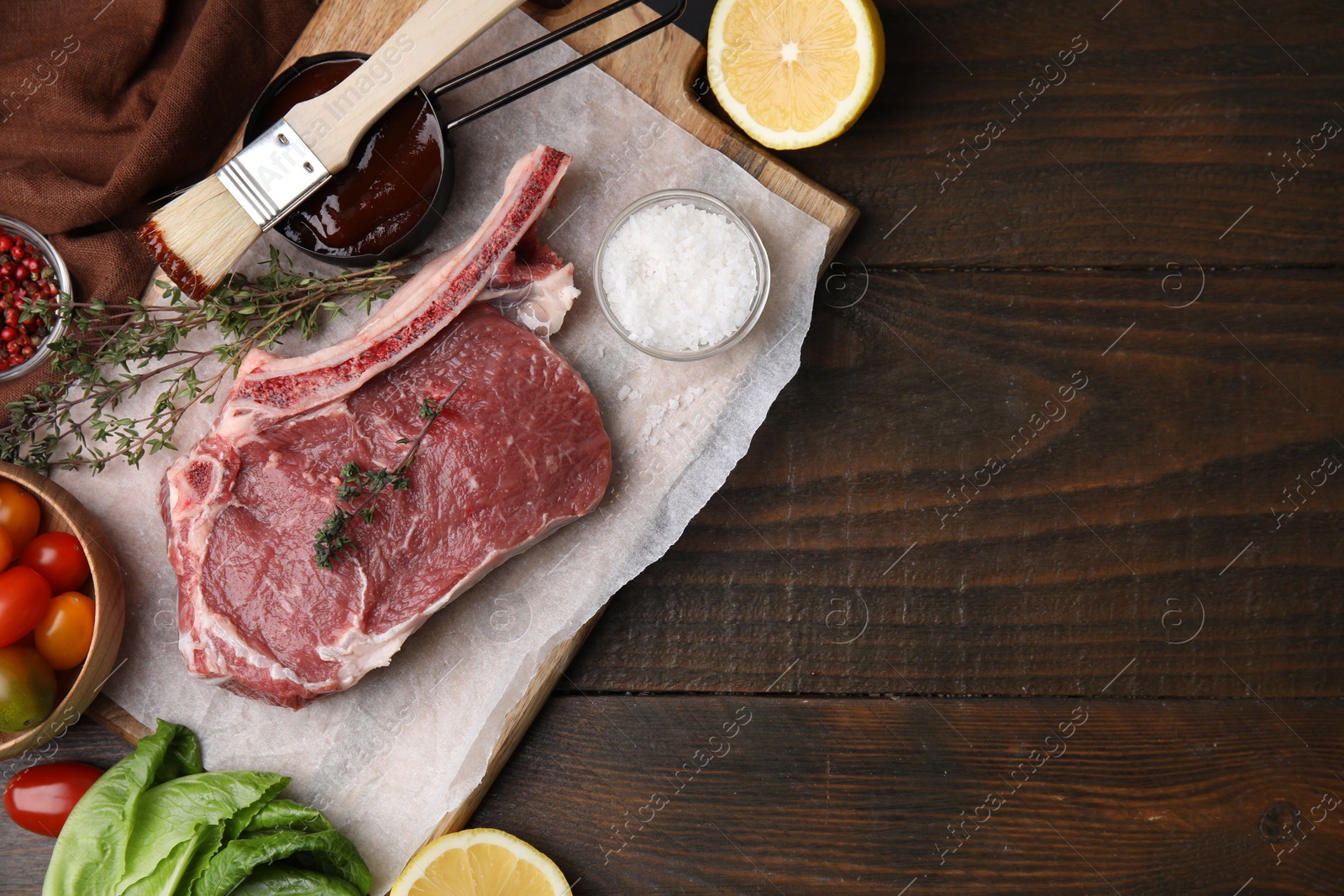 Photo of Flat lay composition with raw meat, thyme and marinade on wooden table. Space for text