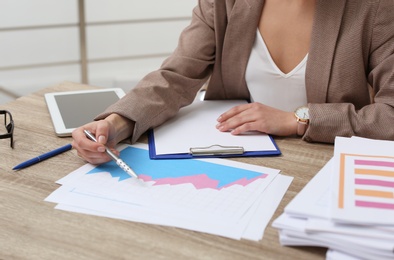 Photo of Businesswoman working with documents at office table, closeup