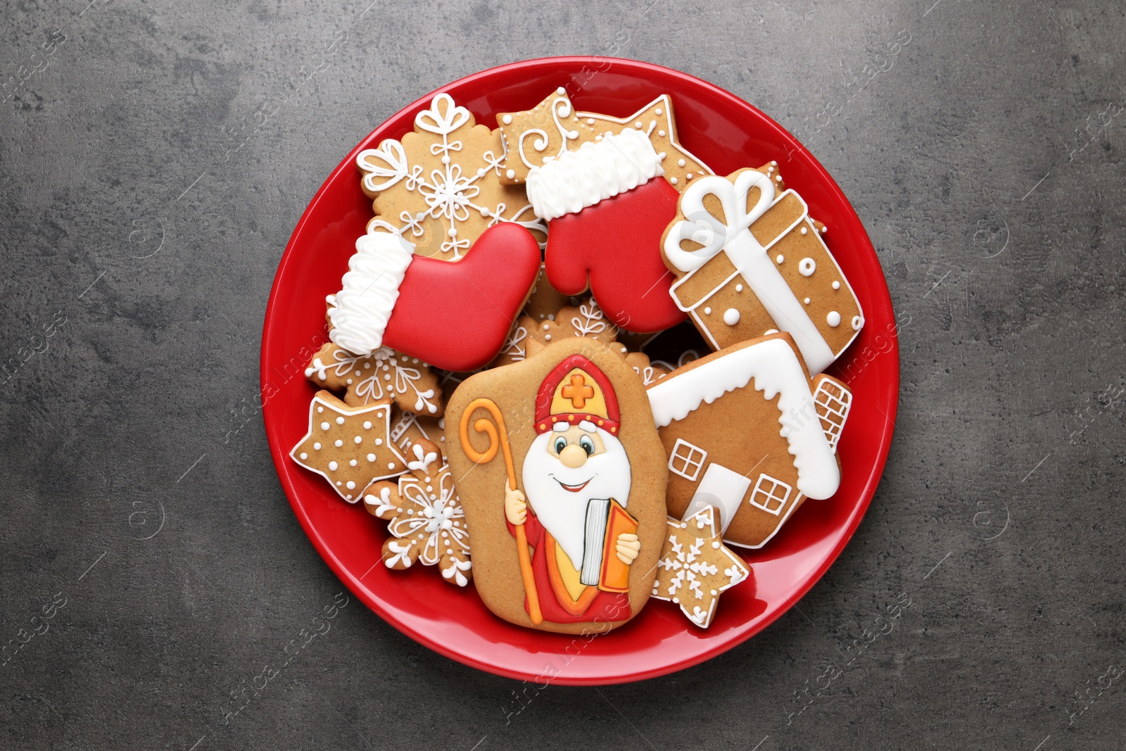 Photo of Tasty gingerbread cookies on grey table, top view. St. Nicholas Day celebration