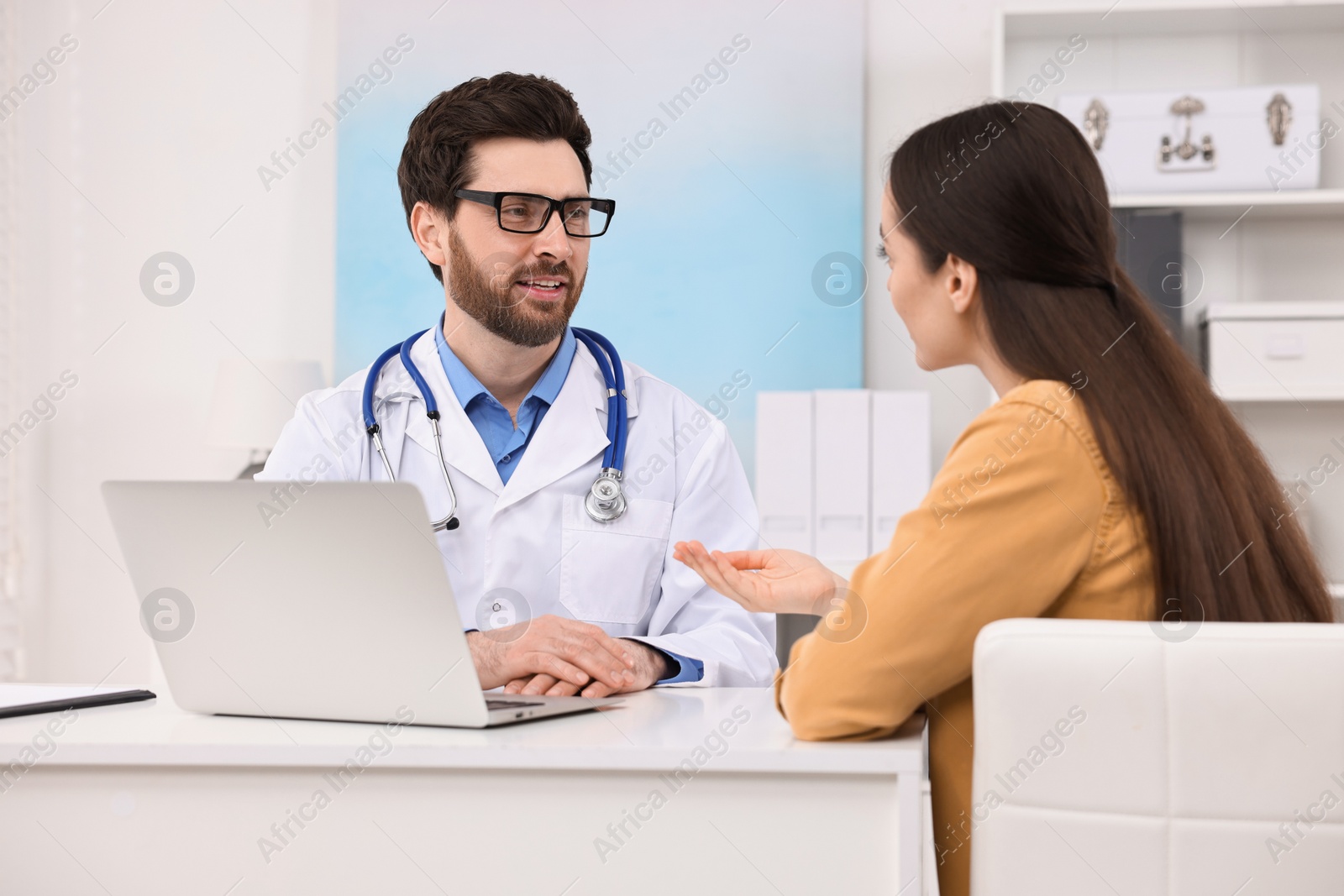 Photo of Doctor consulting patient during appointment in clinic