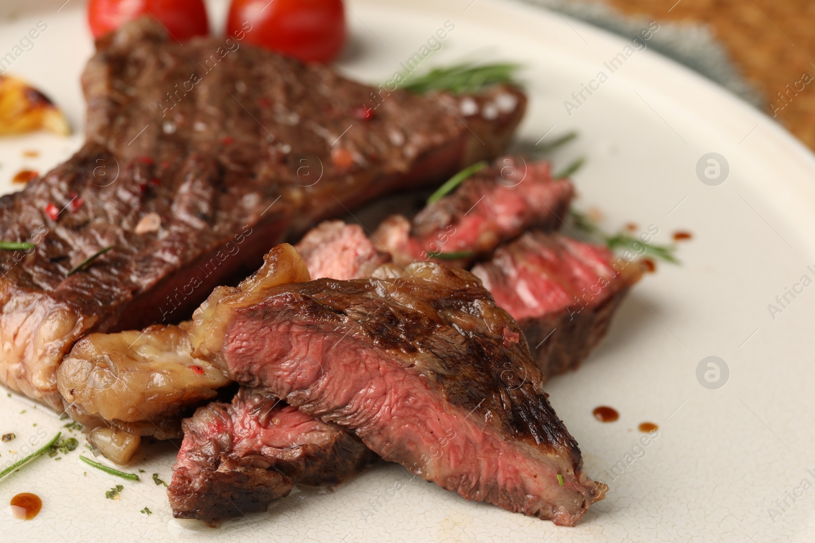 Photo of Delicious grilled beef steak on plate, closeup