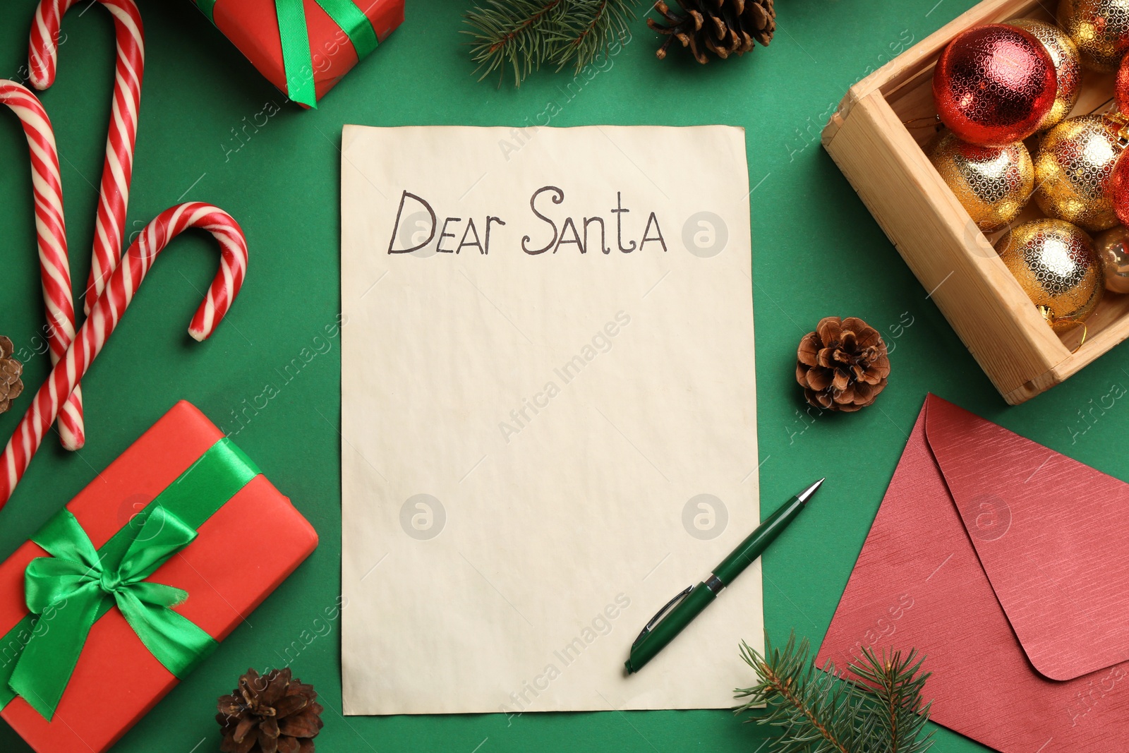 Photo of Flat lay composition with letter saying Dear Santa on green background. Space for text