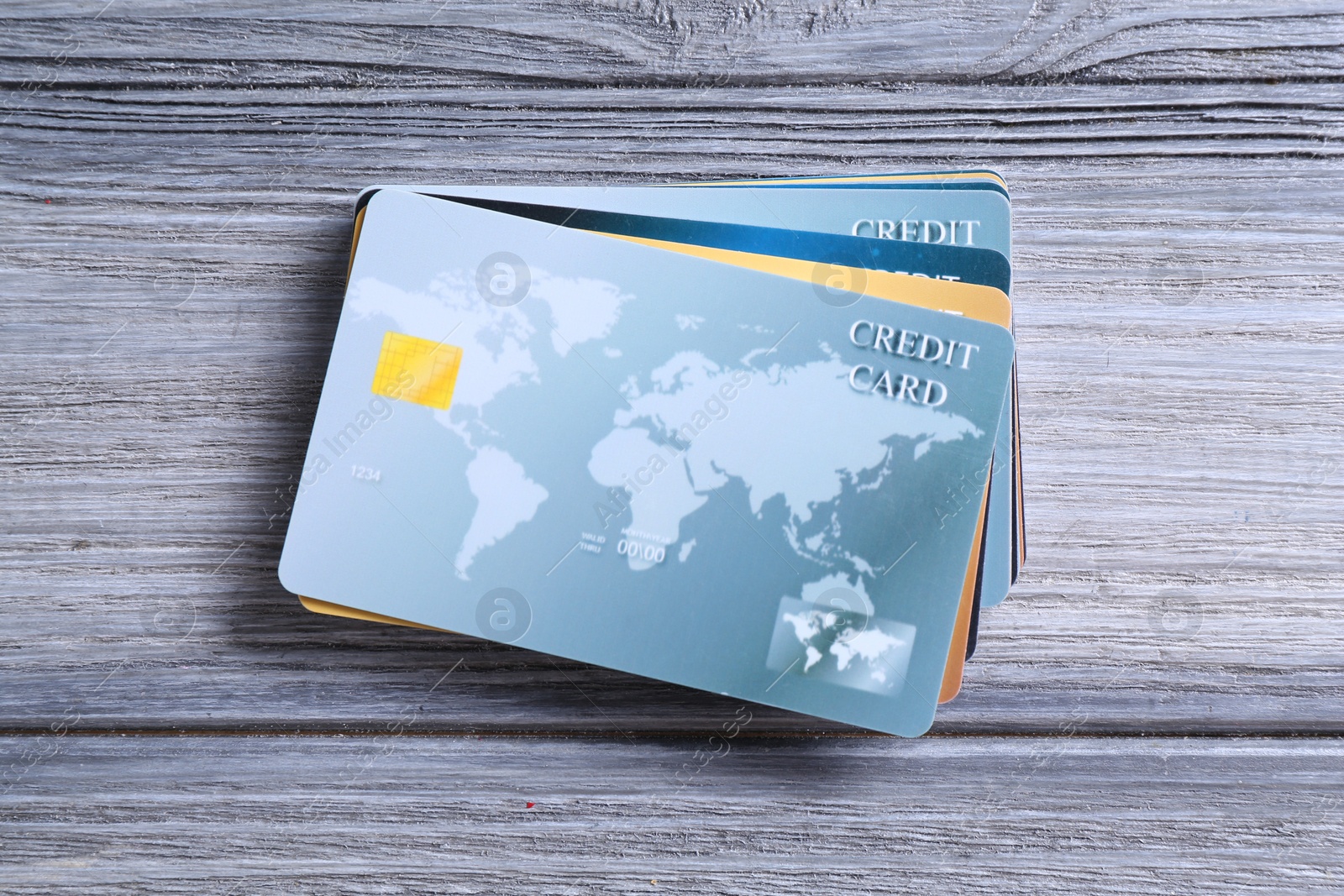 Photo of Credit cards on grey wooden table, top view