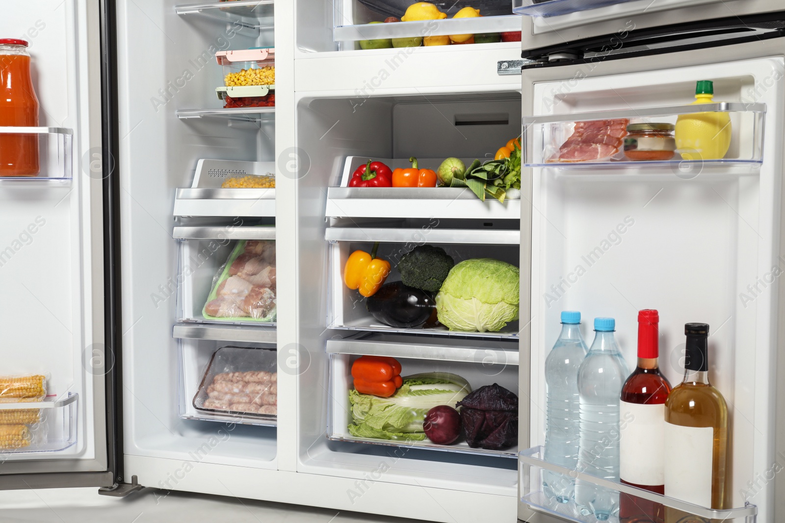 Photo of Open refrigerator full of different fresh products