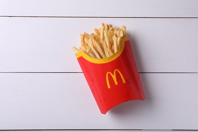 Photo of MYKOLAIV, UKRAINE - AUGUST 12, 2021: Big portion of McDonald's French fries on white wooden table, top view