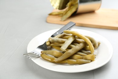 Photo of Canned green beans on light grey table