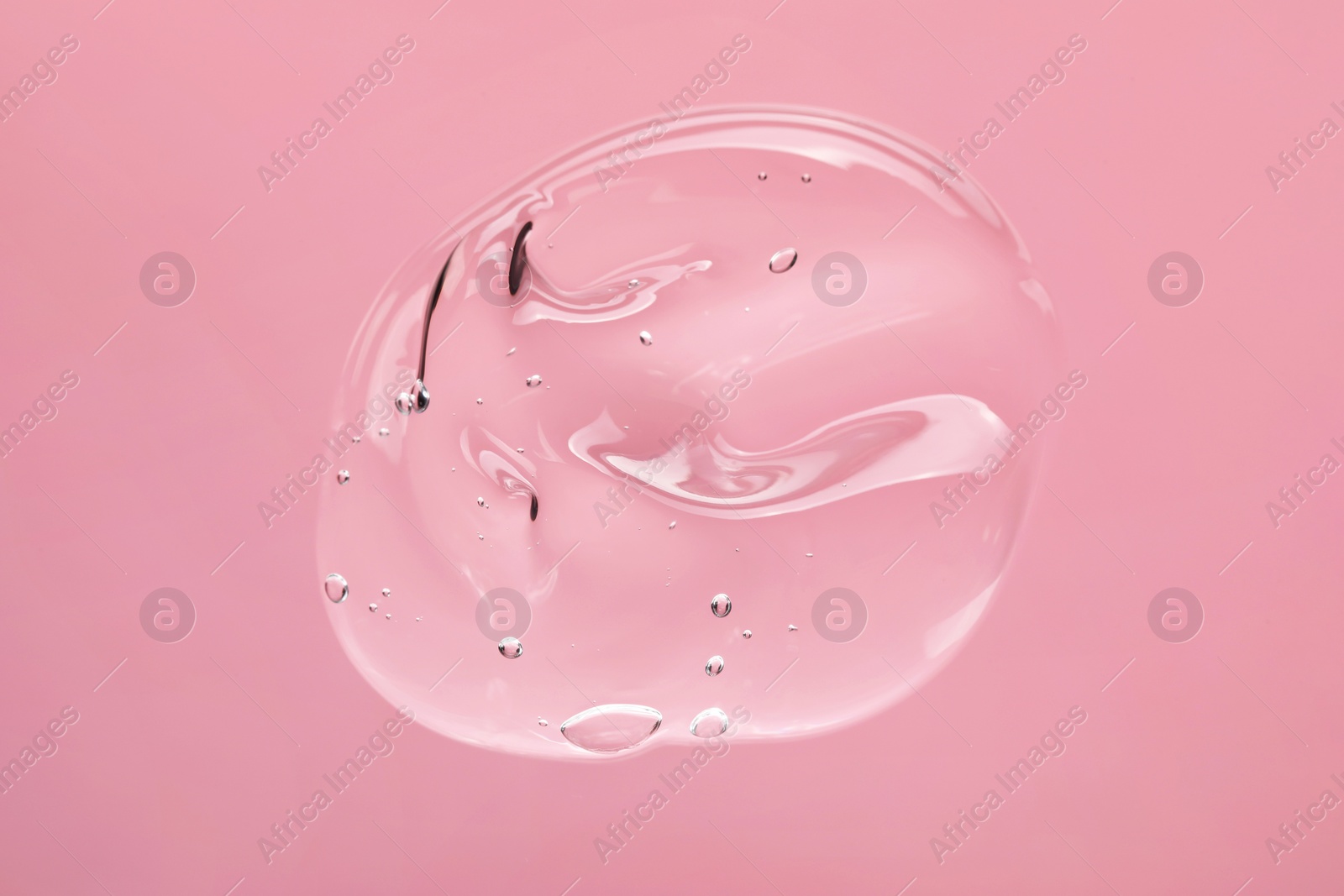 Photo of Sample of cleansing gel on light pink background, top view. Cosmetic product